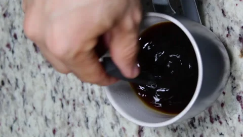 Vertical shot of hands serving hot black coffee with milk 動画素材 140928069