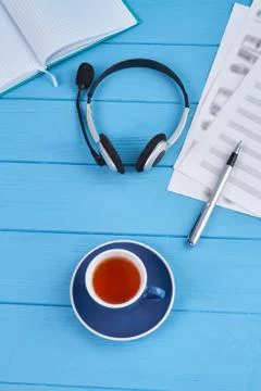 Vertical shot headset with cup of tea. Stock Photos
