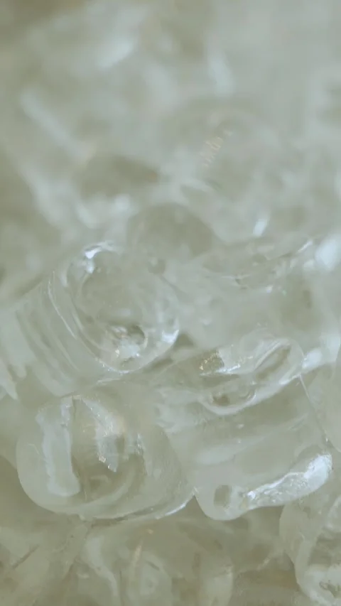 Vertical shot. Ice cubes in a clear bowl enhance the presentation and cooling Stock Footage 306156468
