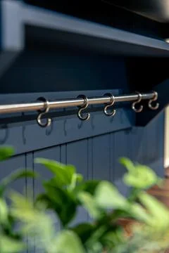 Vertical shot of kitchen rail system with hooks. Functional storage under a.. Foto stock