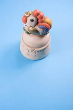 Vertical shot of a kitchen timer on a blue background Stock Photos