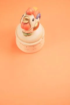 Vertical shot of a kitchen timer on an orange background Stock Photos