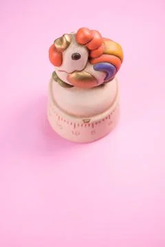 Vertical shot of a kitchen timer on a pink background Stock Photos