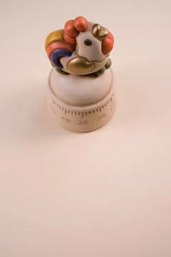 Vertical shot of a kitchen timer on a white background Stock Photos