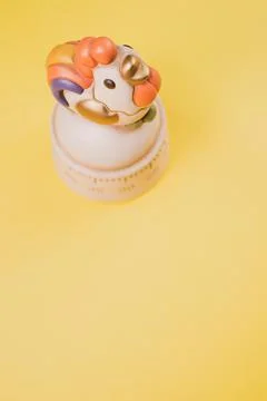 Vertical shot of a kitchen timer on a yellow background Stock Photos