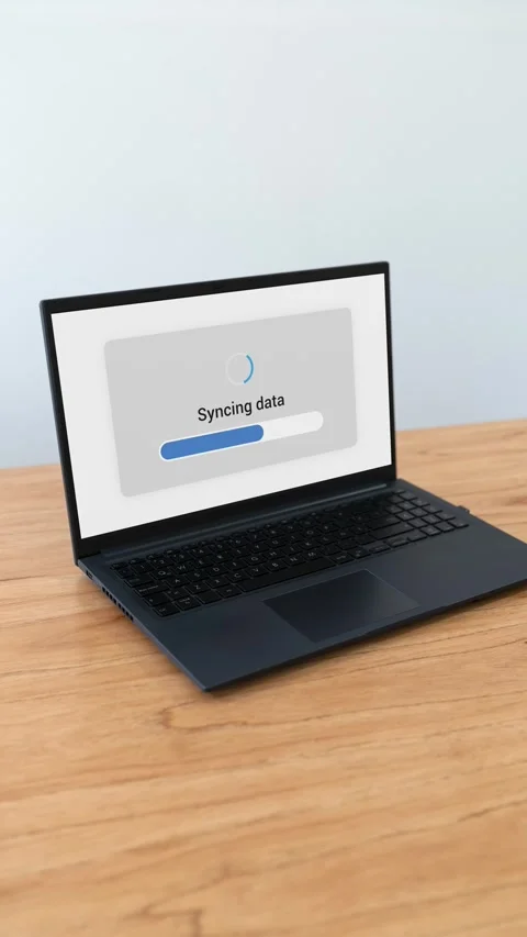 Vertical shot of laptop syncing data with cloud storage service. Video stock 310334525