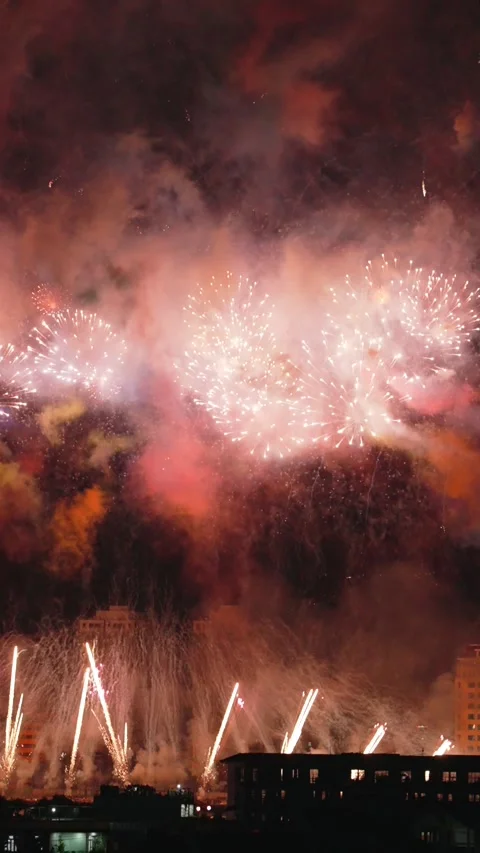 Vertical shot of Large Fireworks and Fan Mines Bursting in the Night Sky Stock Footage 343328323