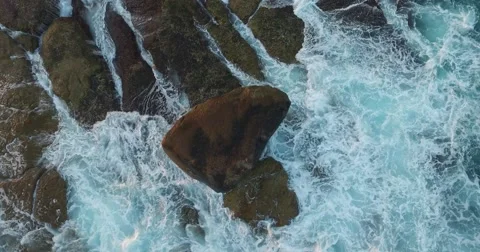 Vertical Shot of Large surf crashing against a rock Stock Footage 60936935