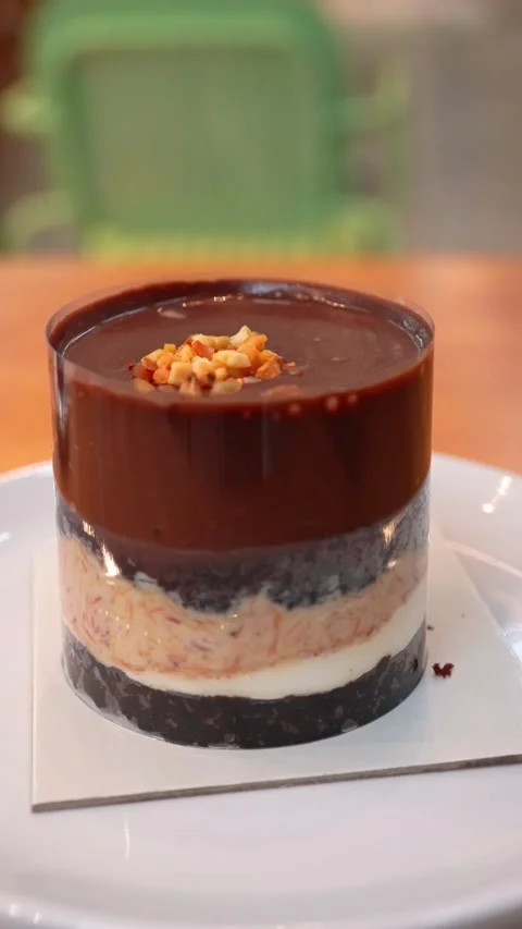 Vertical Shot of Layered Chocolate and Biscuit Dessert on Rotating Stand Stock Footage 332341430