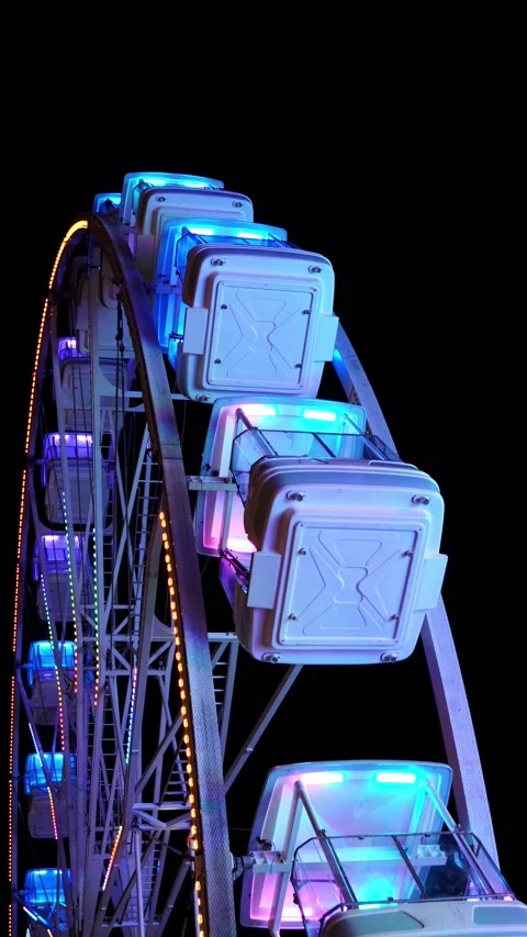 Vertical shot of lighted up ferris wheel at night Stock Footage 217411195