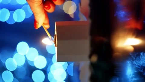 A vertical shot of lighting a soy candle with a match. Stockbeeldmateriaal 264582141
