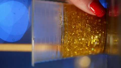 A vertical shot of the magic of mixing epoxy resin with glitter. Stock Footage 261515898