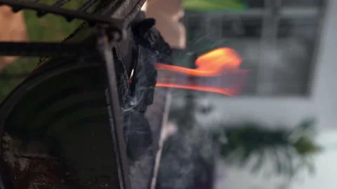 Vertical shot - man makes fire with charcoal on a grill Stock Footage 172163941