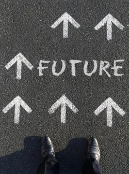 A vertical shot of a man standing in front of the word Future written on the  Stock Photos
