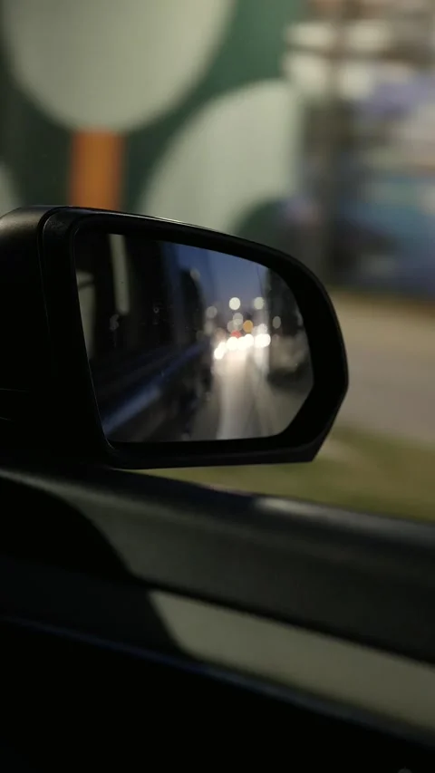 Vertical shot of mirror of car during night drive in city on holiday Stockbeeldmateriaal 221581657