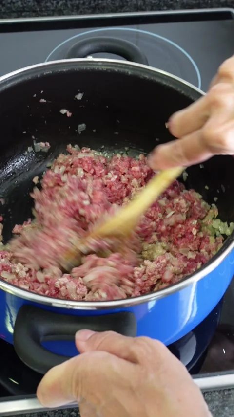 Vertical shot of mixing minced beef and chopped onions Stock Footage 283276611