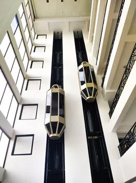 Vertical shot of modern elevators moving up in the business center 库存照片