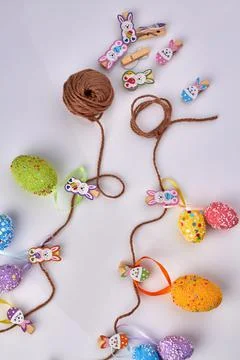 Vertical shot of motley easter eggs with thread. Stock Photos