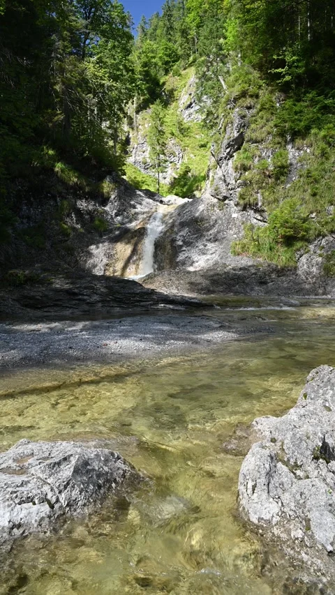 Vertical shot mountain stream in front of a waterfall in summer Stock Footage 260909775