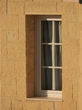 Vertical shot of a narrow rectangular window of a building 스톡 사진