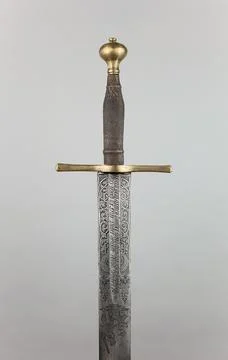 Vertical shot of a pattern sword on shite background Foto stock