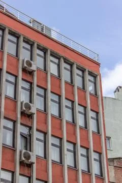 Vertical shot of perspective multi storey building orange colored facade at A Foto stock