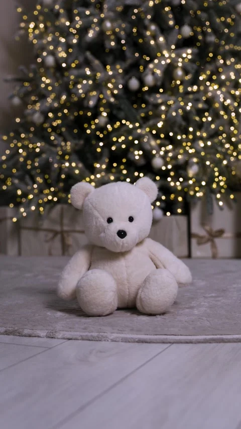 Vertical shot of a plush teddy bear on a soft rug with Christmas lights Stock Footage 323224107