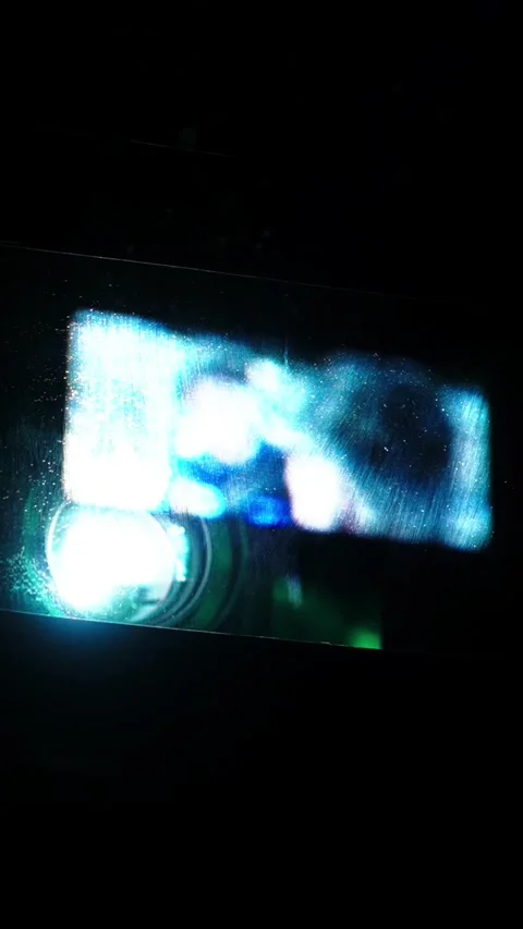 Vertical Shot Projecting film frames creating glowing abstract patterns and Stock Footage 340564039