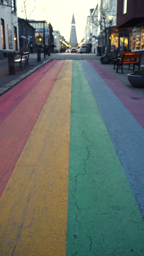 Vertical shot of a rainbow painted street in a Nordic city at sunrise with .. Stock Footage 329865017