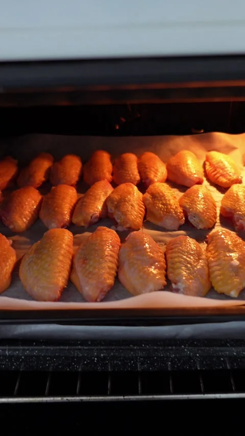 Vertical shot with raw chicken wings inside oven Stock Footage 296489045