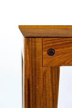 Vertical shot of a rectangular wooden table detail isolated in a white setting 스톡 사진