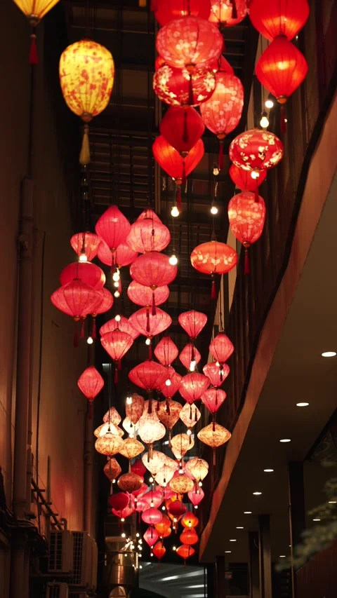Vertical shot of Red and Gold Chinese Lanterns Hanging in Chinatown Alley at Stock Footage 341780202