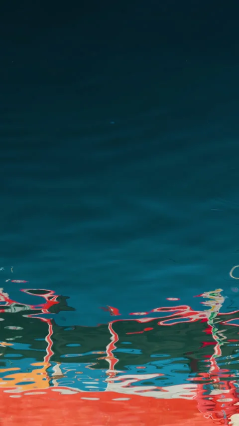 Vertical shot. Reflection and specular reflection of boats in blue water.  Stock Footage 283374700