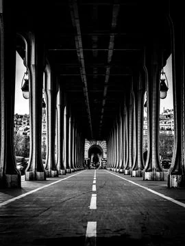 Vertical shot of a road under the Eiffel Tower in Paris, France. Black and white Stock Photos