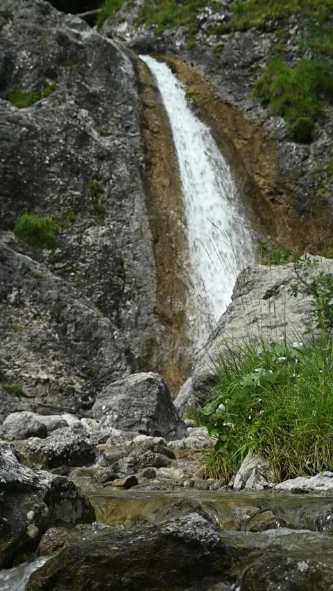Vertical shot of rocks, a waterfall and a mountain stream, slow motion Stock-Footage 260891196