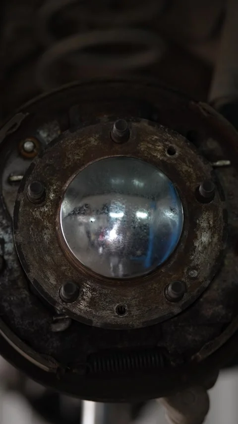 Vertical shot of a round shiny metal wheel hub cap. Stock Footage 344230406