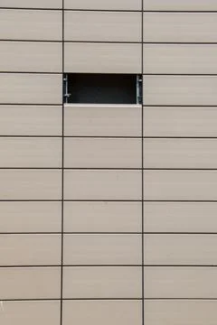 Vertical shot of rows of rectangular wooden spaces with one empty Stock Photos