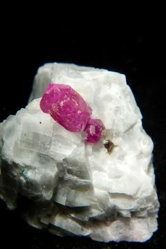 Vertical shot of a Ruby stone isolated on a black background Stock Photos