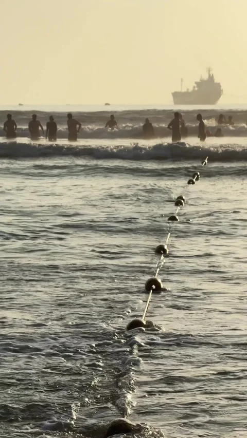 Vertical shot of Safety Buoy Line in sea Waves. Public beach swimming zone Stock Footage 342472047