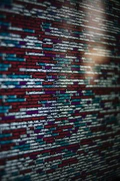 A vertical shot of a screen with HTML JavaScript source code for web page dev Stock-Fotos