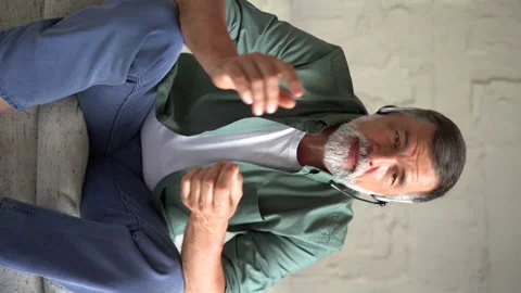Vertical shot of senior man talking at camera sit on sofa communicate by webcam Stock Footage 158838727