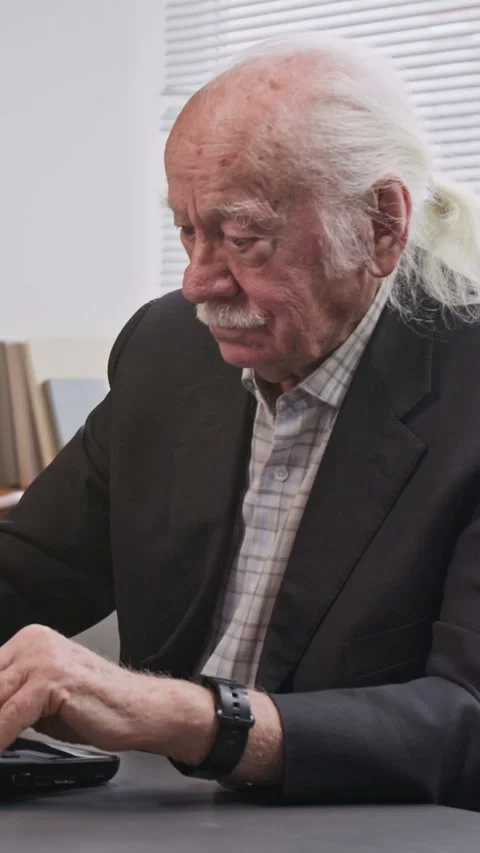 Vertical Shot of Senior Man Using Laptop in Retirement Home Stock Footage 333711283