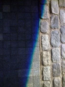 A vertical shot of a shadow covering a surface made of rectangular and square Stock Photos
