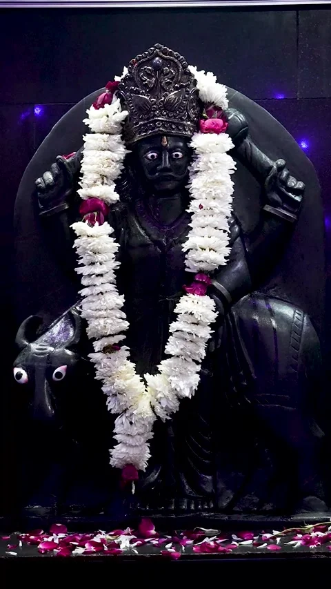 Vertical Shot of Shani Dev Idol Decorated with Garland Stock Footage 323098729