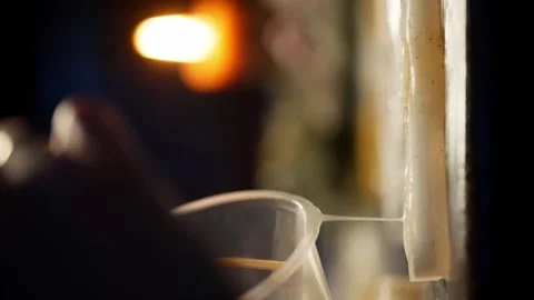 A vertical shot showing a close-up of the material being poured into the mold. Video stock 259083977