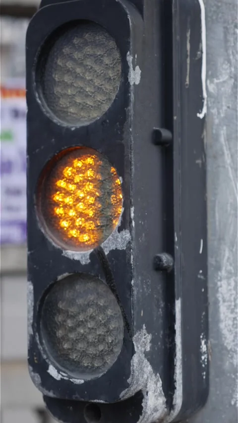 A vertical shot shows a traffic light changing signals, highlighting structured Stock Footage 324853444