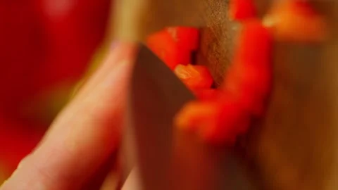 Vertical shot of slicing a red pepper into squares with a large knife. Stock Footage 296363452