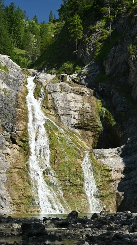 Vertical shot of a slow moving waterfall in late summer Video stock 260882126