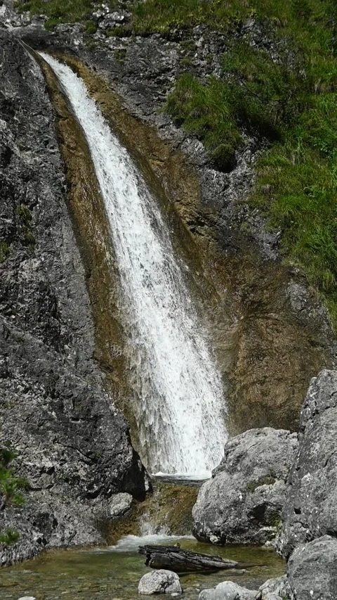Vertical shot of a small stoney mountain stream, slow motion Stock-Footage 260890963