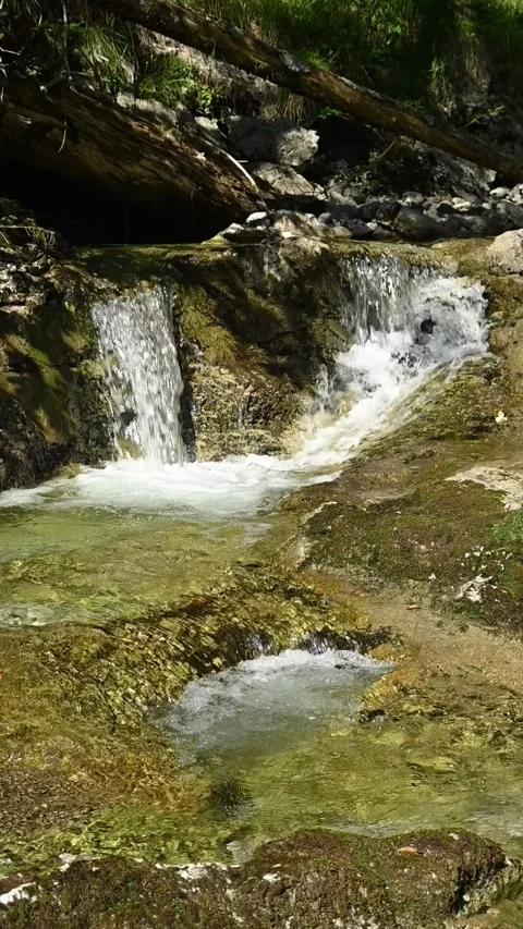 Vertical shot of a small waterfall from a mountain stream in a forest, slow-mo Stock-Footage 260885118